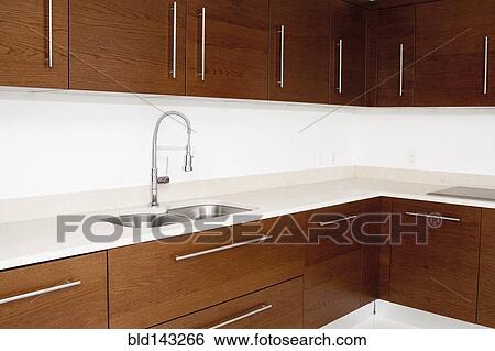 Sink and cabinets in modern kitchen View Large Photo Image Stock Photograph - Sink and cabinets in modern kitchen. Fotosearch