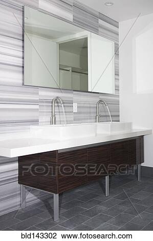 Stock Image - Sinks and mirror in modern bathroom. Fotosearch