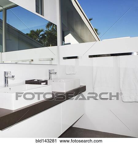 Stock Image - Sinks, mirror and counters in modern bathroom. Fotosearch