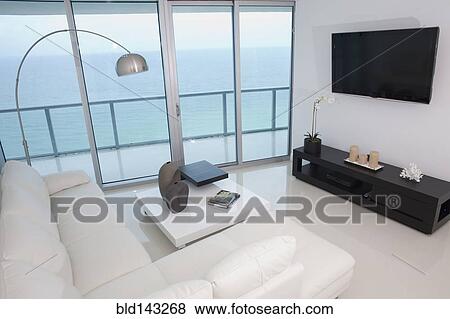 Stock Photo - Sofa, coffee table and television in modern living room. Fotosearch