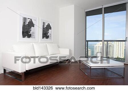 Sofa, coffee table and windows in modern living room View Large Photo Image Stock Photograph - Sofa, coffee table and windows in modern living room. Fotosearch