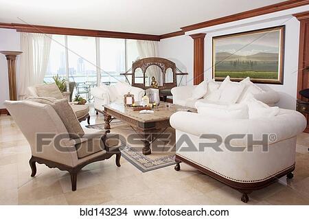Picture - Sofas, armchairs and coffee table in ornate living room. Fotosearch