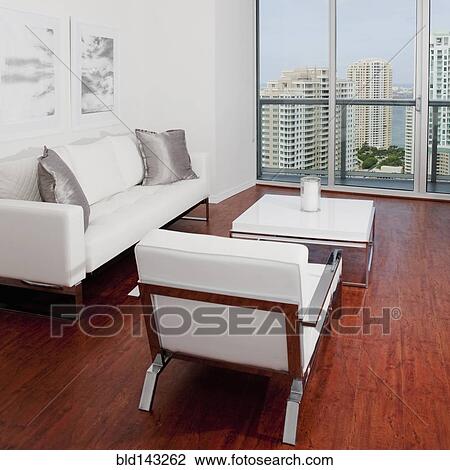 Sofas, coffee table and window overlooking high rise buildings in modern living room View Large Photo Image Stock Image - Sofas, coffee table and window overlooking high rise buildings in modern living room. Fotosearch