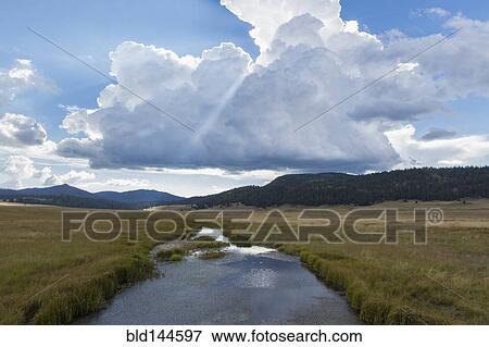 Still river and grassy field in remote landscape View Large Photo Image Stock Photo - Still river and grassy field in remote landscape. Fotosearch