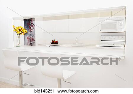 Stools and breakfast bar in modern kitchen View Large Photo Image Stock Image - Stools and breakfast bar in modern kitchen. Fotosearch