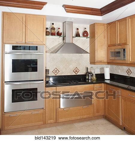Stock Photo - Stove, oven and cabinets in kitchen. Fotosearch