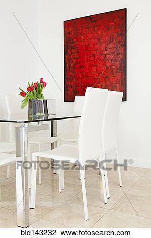 Stock Image - Table, chairs and wall art in modern dining room. Fotosearch