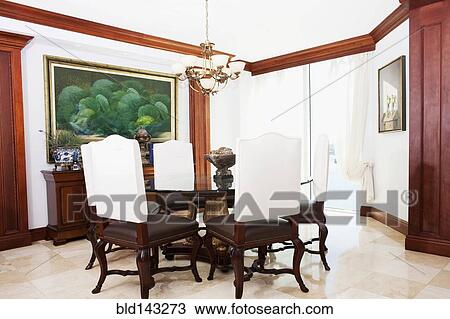 Table, chairs and wall art in ornate dining room View Large Photo Image Stock Image - Table, chairs and wall art in ornate dining room. Fotosearch