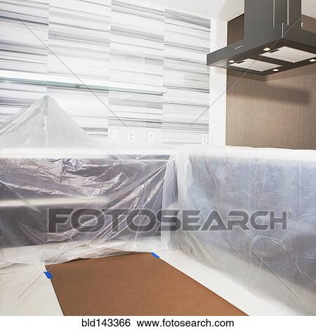 Tarps covering surfaces in modern kitchen under renovation View Large Photo Image Stock Photograph - Tarps covering surfaces in modern kitchen under renovation. Fotosearch