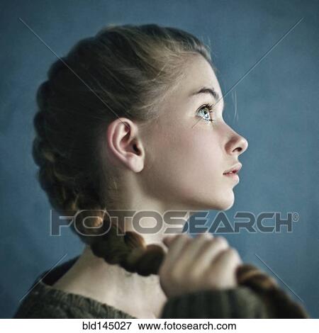 Stock Photo - Teenage girl holding braid. Fotosearch