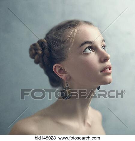 Teenage girl with braided hair wearing dangling earrings View Large Photo Image Stock Photo - Teenage girl with braided hair wearing dangling earrings. Fotosearch