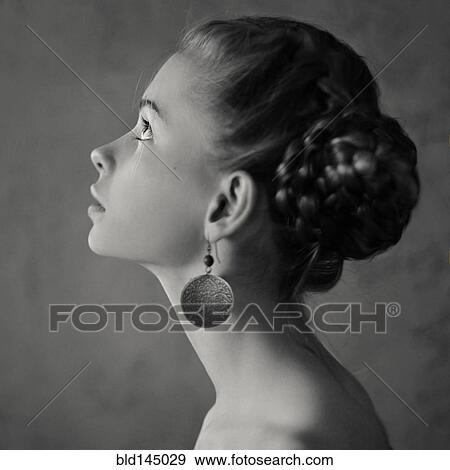Teenage girl with braided hair wearing dangling earrings View Large Photo Image Stock Photo - Teenage girl with braided hair wearing dangling earrings. Fotosearch