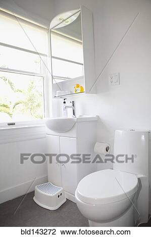 Stock Image - Toilet, sink and mirror in modern bathroom. Fotosearch