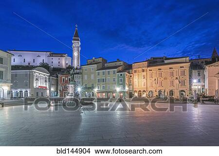 Picture - Town square, tower and buildings illuminated at night, Piran, Coastal-Karst, Slovenia. Fotosearch