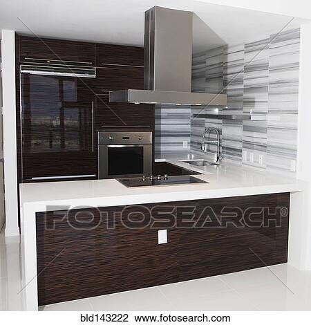 Vent, stove and countertop in empty modern kitchen View Large Photo Image Stock Image - Vent, stove and countertop in empty modern kitchen. Fotosearch
