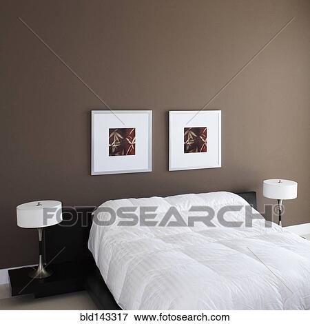 Wall art, lamps and bed in modern bedroom View Large Photo Image Stock Photo - Wall art, lamps and bed in modern bedroom. Fotosearch