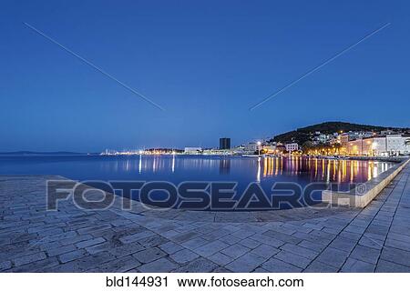 Waterfront sidewalk, illuminated boats and dock at dusk, Split, Split, Croatia View Large Photo Image Stock Image - Waterfront sidewalk, illuminated boats and dock at dusk, Split, Split, Croatia. Fotosearch