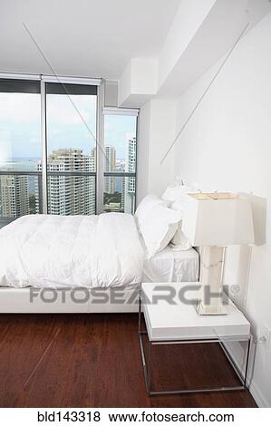 Window, lamps and bed in modern bedroom View Large Photo Image Stock Photo - Window, lamps and bed in modern bedroom. Fotosearch