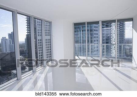Windows of empty modern apartment overlooking cityscape View Large Photo Image Stock Photography - Windows of empty modern apartment overlooking cityscape. Fotosearch