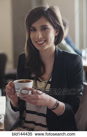Stock Photography - Woman drinking cup of coffee in cafe. Fotosearch