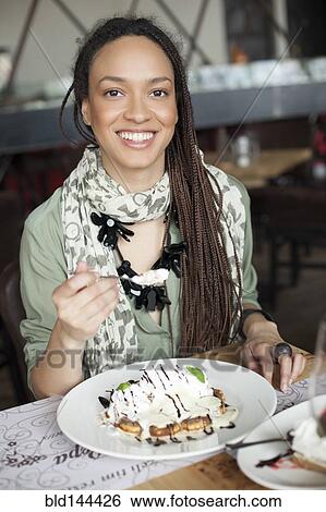 Woman eating dessert in cafe View Large Photo Image Stock Photograph - Woman eating dessert in cafe. Fotosearch