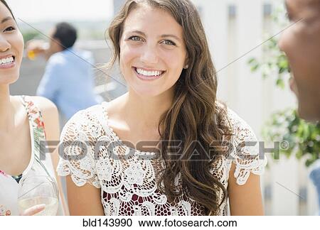 Woman smiling at party View Large Photo Image Stock Image - Woman smiling at party. Fotosearch