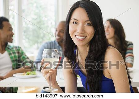 Stock Photo - Woman smiling at restaurant. Fotosearch