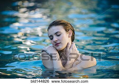 Stock Photograph - Woman swimming in lake. Fotosearch