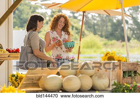 Women browsing fruit at farmers market View Large Photo Image Stock Image - Women browsing fruit at farmers market. Fotosearch