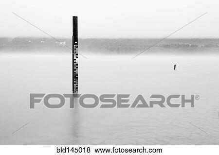 Wooden measuring post in water View Large Photo Image Stock Photo - Wooden measuring post in water. Fotosearch