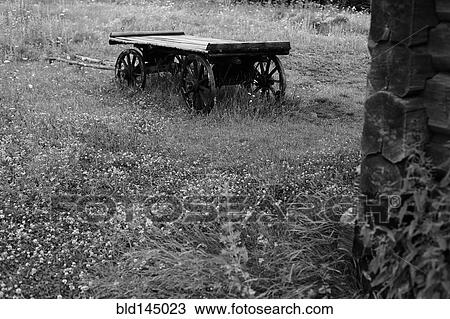 Wooden wagon in rural field View Large Photo Image Stock Image - Wooden wagon in rural field. Fotosearch