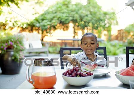 African American boy eating lunch on patio View Large Photo Image Stock Image - African American boy eating lunch on patio. Fotosearch