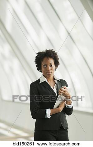 Stock Image - African American businesswoman holding digital tablet. Fotosearch