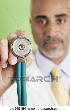 African American doctor holding stethoscope View Large Photo Image Picture - African American doctor holding stethoscope. Fotosearch