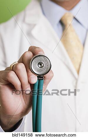 African American doctor holding stethoscope View Large Photo Image Stock Photo - African American doctor holding stethoscope. Fotosearch
