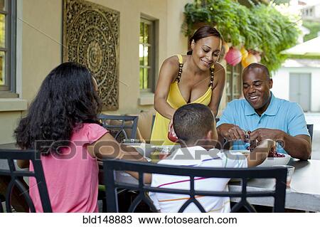 African American family eating lunch on patio View Large Photo Image Stock Image - African American family eating lunch on patio. Fotosearch