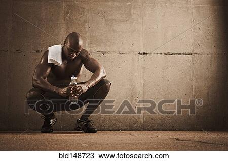 African American man drinking water after exercise View Large Photo Image Stock Image - African American man drinking water after exercise. Fotosearch