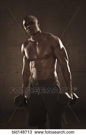 African American man holding hand weights View Large Photo Image Stock Image - African American man holding hand weights. Fotosearch