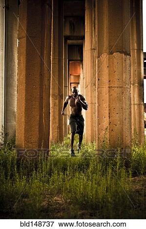 African American man jogging between pillars View Large Photo Image Stock Photo - African American man jogging between pillars. Fotosearch