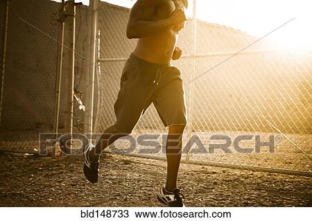 Stock Image - African American man jogging. Fotosearch