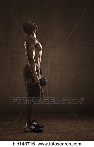African American man lifting weights View Large Photo Image Stock Photograph - African American man lifting weights. Fotosearch