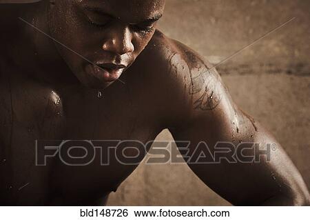 Stock Photograph - African American man sweating after exercise. Fotosearch