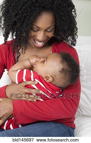 African American woman holding baby son View Large Photo Image Stock Photo - African American woman holding baby son. Fotosearch