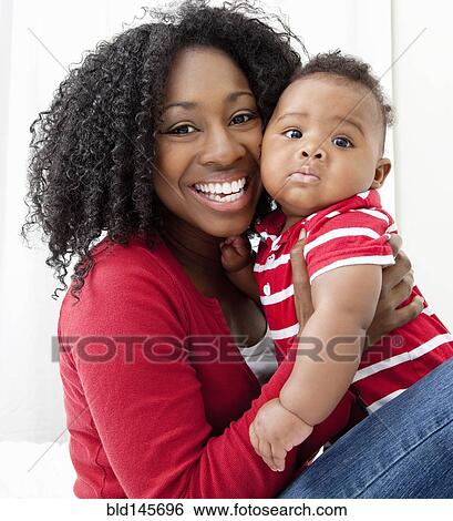 African American woman holding baby son View Large Photo Image Stock Photograph - African American woman holding baby son. Fotosearch