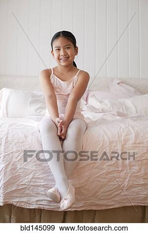 Asian girl in ballet costume sitting on bed View Large Photo Image Stock Photo - Asian girl in ballet costume sitting on bed. Fotosearch