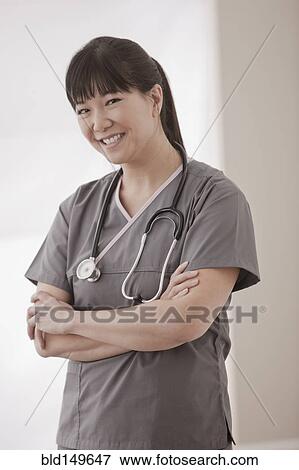 Stock Photo - Asian surgeon with arms crossed. Fotosearch