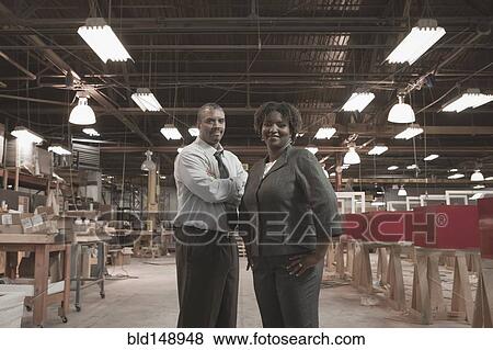 Black business people standing in warehouse View Large Photo Image Stock Photo - Black business people standing in warehouse. Fotosearch