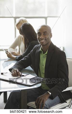 Black businessman smiling in meeting View Large Photo Image Stock Image - Black businessman smiling in meeting. Fotosearch