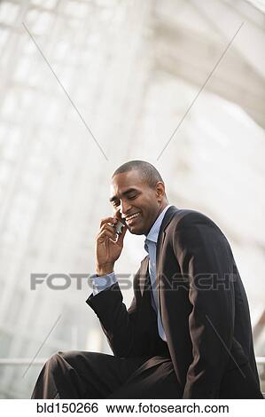Black businessman talking on cell phone View Large Photo Image Stock Photograph - Black businessman talking on cell phone. Fotosearch