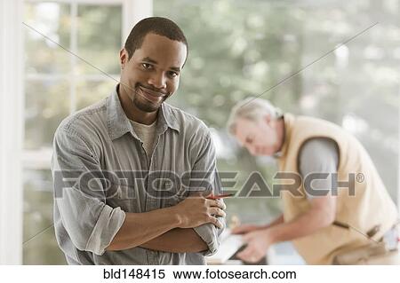 Black carpenter standing with arms crossed View Large Photo Image Stock Photography - Black carpenter standing with arms crossed. Fotosearch